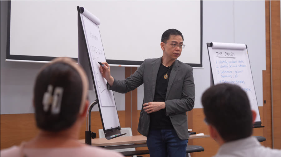 Stuart Tan working a flipchart with participants