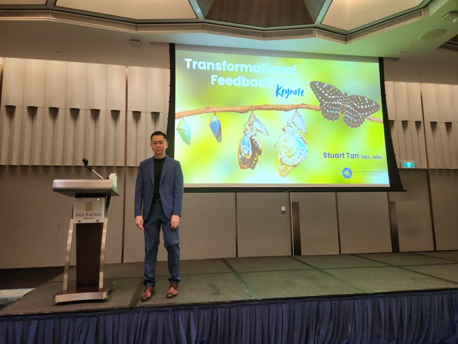 Stuart Tan on stage at a keynote